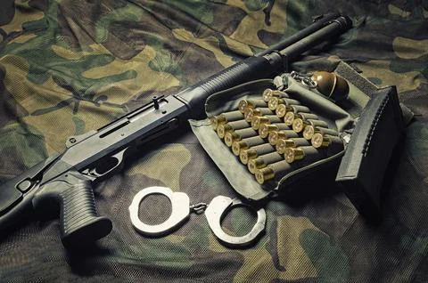 Set of weapons of a fighter of a special unit. Shotgun, ammo, grenade and h.. Stock Photos