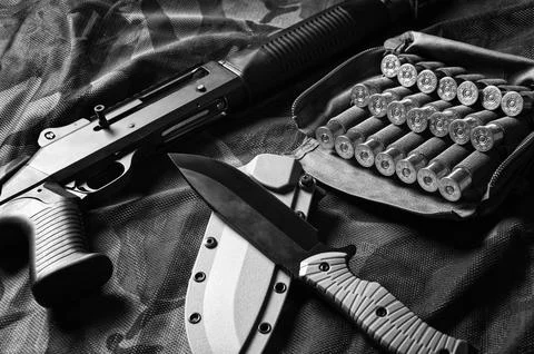 Set of weapons of a fighter of a special unit. Shotgun, cartridges, knife. .. Stock Photos