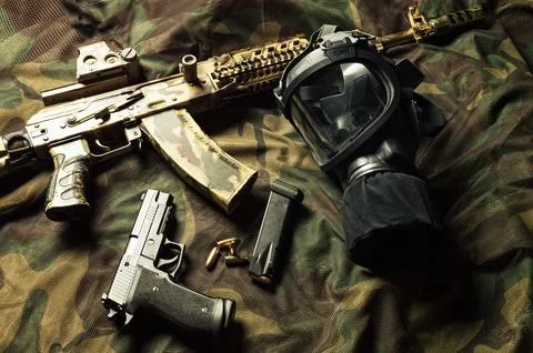 Set of weapons of a fighter of a special unit. Machine gun, gas mask, gun. .. Stock Photos