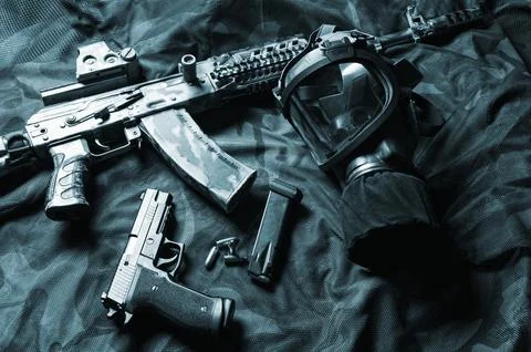 Set of weapons of a fighter of a special unit. Machine gun, gas mask, gun. .. Stock Photos