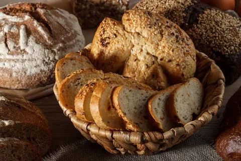 Set of wheat and rye bread with a spoon of salt on a wooden background Stock Photos