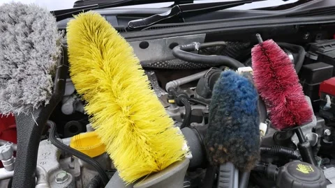 Set of wheel cleaning brushes on a engine deck of Nissan Pulsar Video stock 139421681