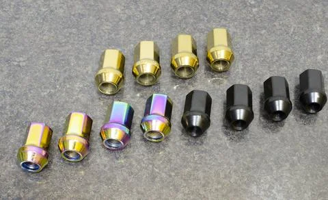 Set of wheel nuts of the car of different color Stock Photos