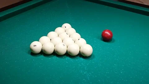 Set of white balls and one red. Russian billiards on a green pool table. Th.. Stock Photos
