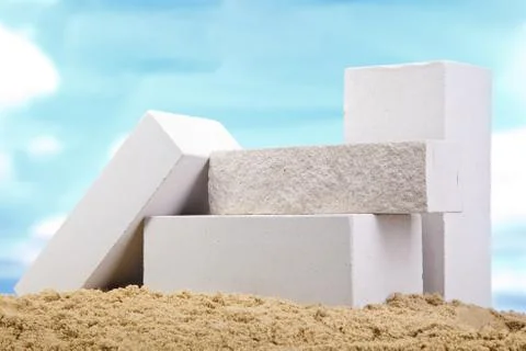 Set of white ceramic bricks on the sand at the blue sky background Stock Photos