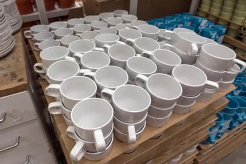 Set of white cups in the store Stock Photos