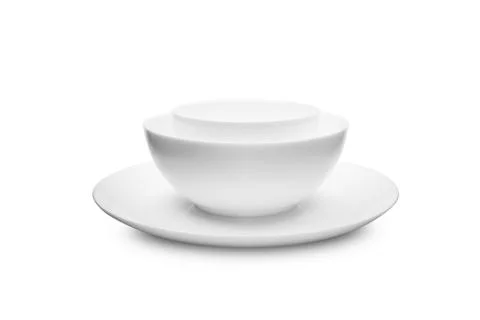 Set of white dishes on table on light background. Stock-Fotos