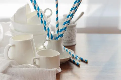 Set of white empty tableware with striped tubules 스톡 사진