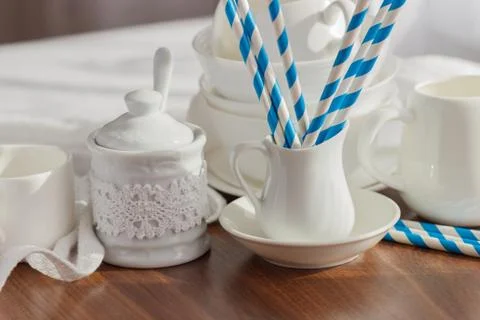 Set of white empty tableware with striped tubules 写真素材