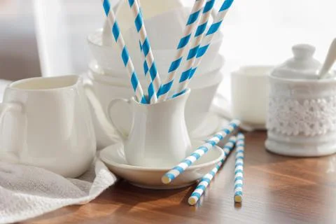 Set of white empty tableware with striped tubules Stock Photos