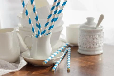 Set of white empty tableware with striped tubules 스톡 사진