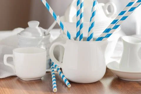 Set of white empty tableware with striped tubules Stock Photos