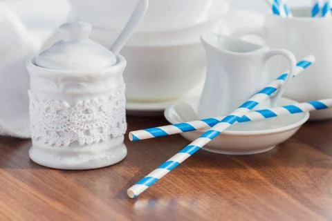 Set of white empty tableware with striped tubules Stock Photos