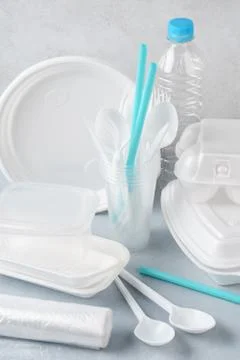 Set of white plastic disposable tableware and packaging. Stock Photos