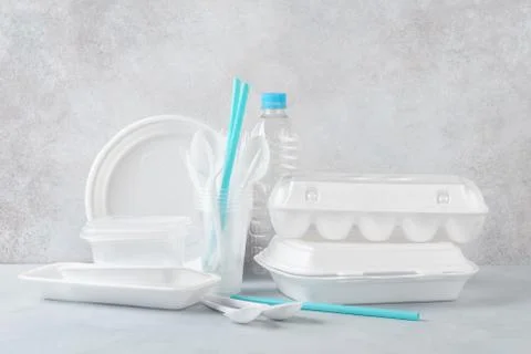 Set of white plastic disposable tableware and packaging. Stock Photos