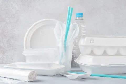 Set of white plastic disposable tableware and packaging. Stock Photos