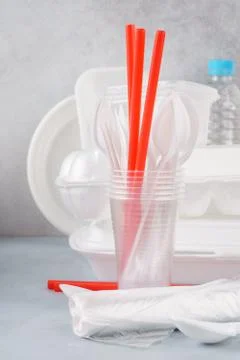 Set of white plastic disposable tableware and packaging. Stock Photos