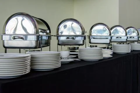 Set of white plates on the table with black tablecloth preparing for the Banq Stock Photos