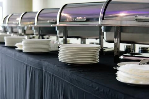 Set of white plates on the table with black tablecloth preparing for the Banq Stock Photos