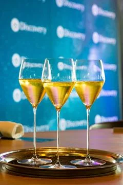 Set of white wine glasses on a table Stock Photos