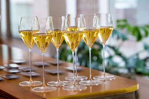 Set of white wine glasses on a table Stock Photos