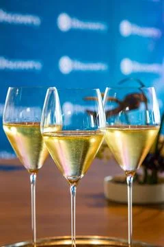 Set of white wine glasses on a table Stock Photos