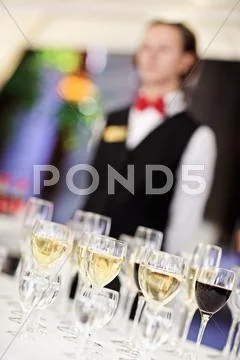 Set of wine glasses with waiter on blurred background Stock Photos