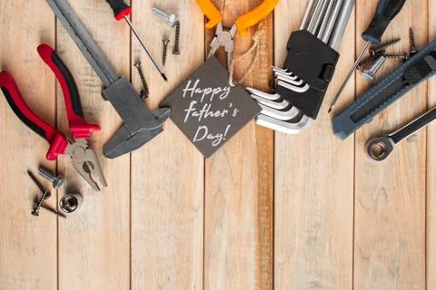 Set of work tools on a wooden background. Festive greeting card concept for F Stock Photos