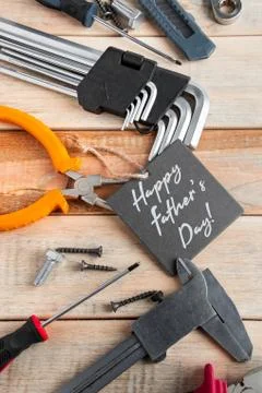 Set of work tools on a wooden background. Festive greeting card concept for F Foto stock