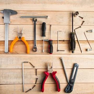 Set of work tools on a wooden background. Festive greeting card concept for.. Stock Photos