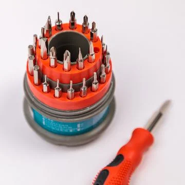 A set of working tools with a screwdriver and bits for repair, in an open pla Stock Photos