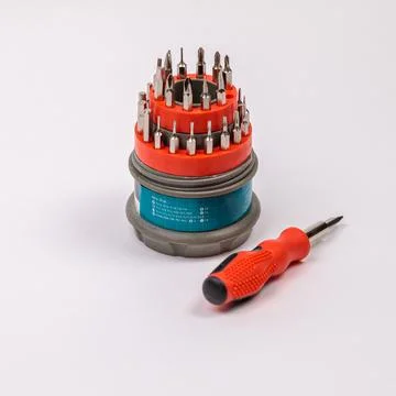 A set of working tools with a screwdriver and bits for repair, in an open pla Stock Photos