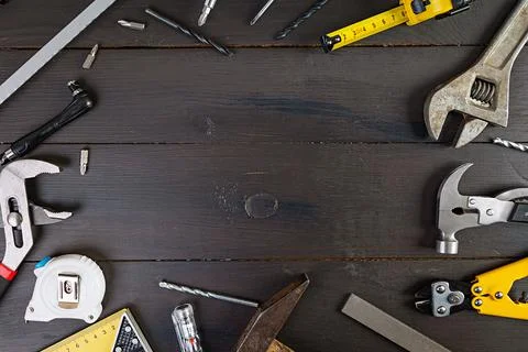 Set of working tools on wooden rustic background. Top view. Copy space Stock Photos