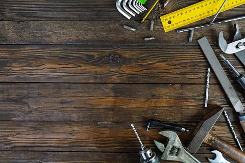 Set of working tools on wooden rustic background. Top view. Copy space Stock Photos