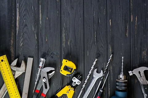 Set of working tools on wooden rustic background. Top view. Copy space Stock Photos