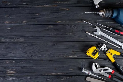 Set of working tools on wooden rustic background. Top view. Copy space Stock Photos
