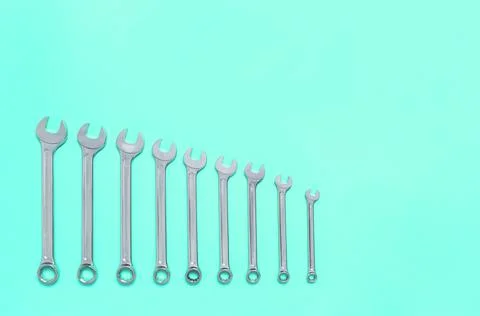 Set of wrenches different size on mint background with copy space, text place Stock Photos
