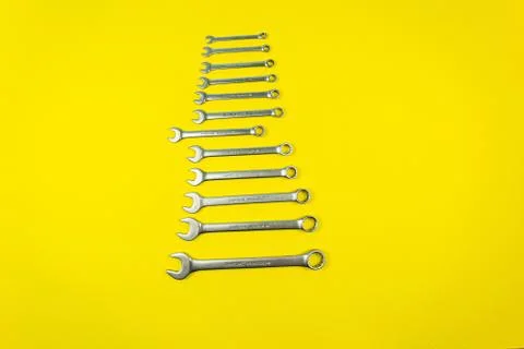 Set of wrenches of different sizes on a yellow background Stock Photos