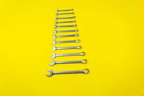 Set of wrenches of different sizes on a yellow background Stock Photos