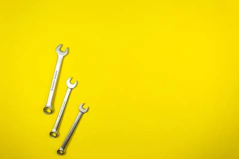 Set of wrenches of different sizes on a yellow background Stock Photos