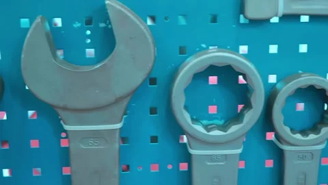 A set of wrenches, including very large ones, hangs on the wall Stock-Footage 333325258