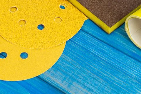 Set of yellow abrasive tools on blue wooden boards Stock Photos