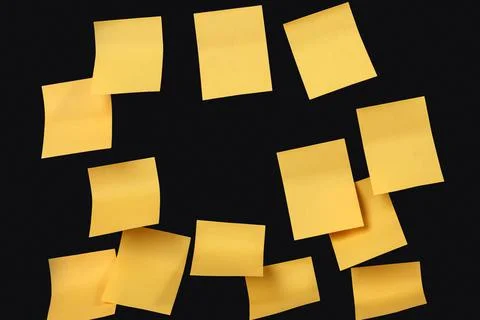 Set of yellow folded note paper sheets on black background Stock Photos