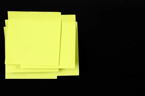 Set of yellow folded note paper sheets on black background Stock Photos