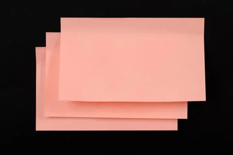 Set of yellow folded note paper sheets on black background Stock Photos