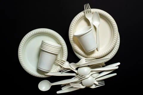 Sets of biodegradable disposable tableware on a black background. Stock Photos