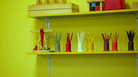 Sets of colored pencils in plastic holders-cups on the shelf. Stock Footage 76417922