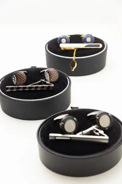 Sets with cufflinks and tie clips on white background. Фото