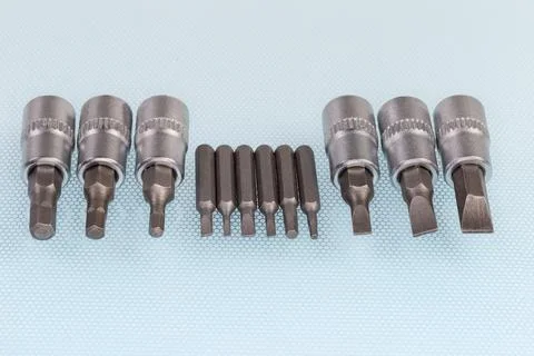 Sets of different interchangeable flat and hexagonal bits for screwdriver Stockfoto's