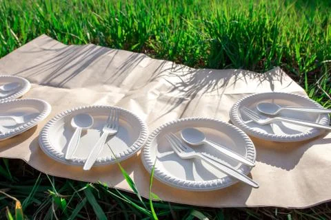Sets of disposable biodegradable glassware on craft paper in nature Фото